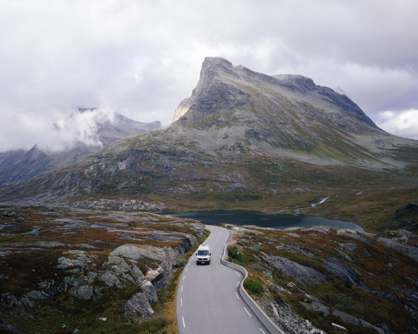 Cabin Campers campervan driving along a scenic mountain road in Norway.