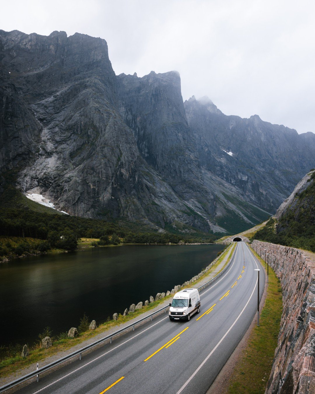 Cabin Campers campervan driving through dramatic Norwegian mountains.